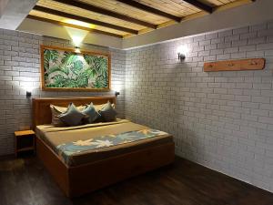 a bedroom with a bed in a brick wall at Cabin 7000 feet Nuwaraeliya in Nuwara Eliya