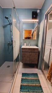 a bathroom with a sink and a shower and a mirror at Beautiful house in the old town of Chania- 4 rooms in Chania Town