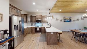 a kitchen with wooden cabinets and stainless steel appliances at Table Rock Lake Luxury Resort Lodge - Boat Slip in Branson