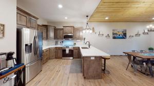 a kitchen with wooden cabinets and stainless steel appliances at Luxury Lake Resort Lodge in Branson