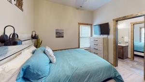 a bedroom with a bed and a sink and a mirror at Table Rock Lake Luxury Resort Lodge - Boat Slip in Branson +33 photos