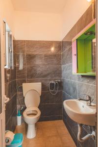 a bathroom with a toilet and a sink at Room with amazing sea view in Himare