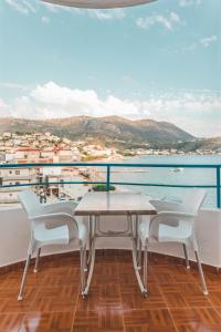 a table and chairs on a balcony with a view of the water at Room with amazing sea view in Himare