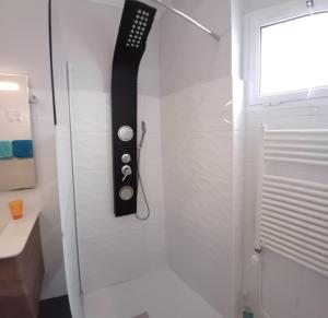 a remote control hanging on a wall in a bathroom at AL - Perola Dourada in Santana