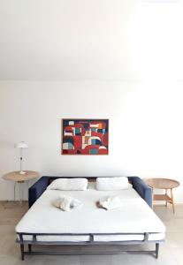 a bed in a room with a painting on the wall at FRGK "Studio Croisette face mer" in Cannes