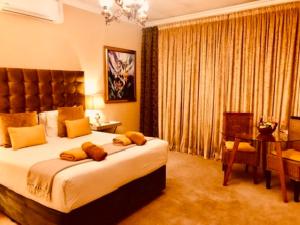 a bedroom with a bed and a table and a desk at 27A on Angus in Johannesburg +100 photos