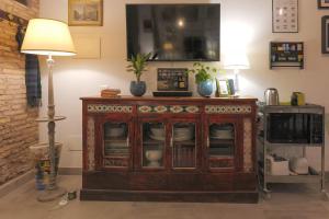 a wooden cabinet with dishes on it with a lamp at Mimma's Ground Floor in Rome +15 photos