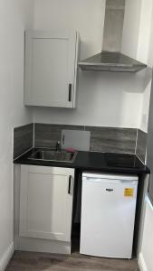 a kitchen with a sink and a counter top at Gregory Boulevard - Stay Sleep Rest in Nottingham