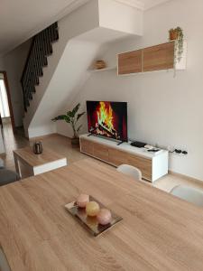 a living room with a table and a fireplace at Casa Trastévere in San Juan de los Terreros