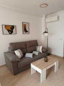 a living room with a couch and a coffee table at Casa Trastévere in San Juan de los Terreros