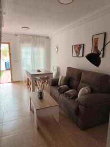 a living room with a couch and a table at Casa Trastévere in San Juan de los Terreros +33 photos