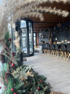 a restaurant with christmas trees in the middle of a room at Roman House Borsa in Borşa