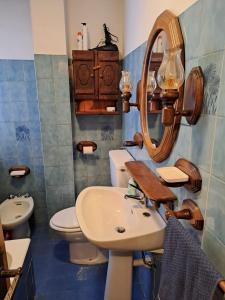 a bathroom with a sink and a toilet and a mirror at Delizioso appartamento in centro a Champoluc in Champoluc