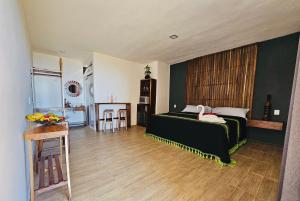 a bedroom with a bed and a table in it at FINCA SAN ANTONIO in Pluma Hidalgo