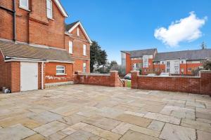 a brick parking lot in front of a brick building at BridgeCity The Sleek Modern Condo - Maidstone Gem - f9 in Kent