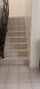 a set of stairs in a building with a tile floor at MAMU'S RESIDENCE near JKIA in Nairobi