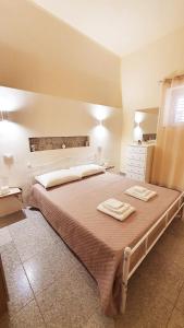 ein Schlafzimmer mit einem großen Bett mit zwei Handtüchern darauf in der Unterkunft Sikelia home holiday in Siculiana