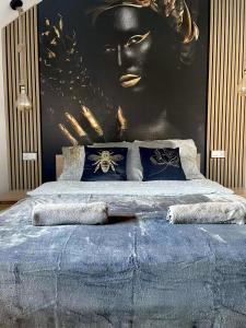 1 dormitorio con 1 cama grande y una pintura de una mujer en Apartament Roku 2024' - JELEŃ & NATURA en Kudowa-Zdrój