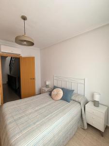 a bedroom with a large bed with blue pillows at Casa Trastévere in San Juan de los Terreros