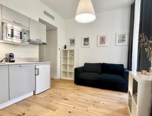 a kitchen and a living room with a couch at Confortable central Studio to discover Nice in Nice