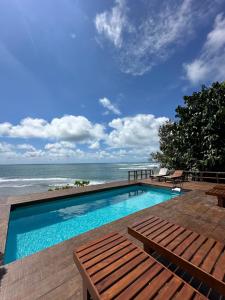 a swimming pool with a view of the ocean at BatuRundung Surf Resort in Naibos