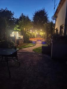 a night time view of a backyard with a pool at TeachinTom in Strabane