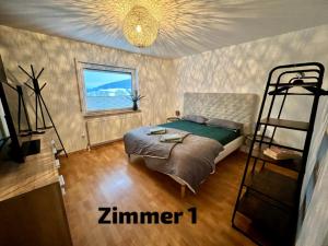 a bedroom with a bed and a bunk bed at ZIMMERAUFZEIT in Bad Kissingen