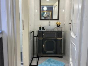 a black bathroom with a sink and a mirror at San Zeno Apartment in Verona