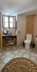 a bathroom with a toilet and a sink at El 6 De Busquet in Cáceres +19 photos