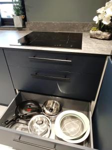 a stove top with pots and pans in a kitchen at Stansted Airport Cottage in Bishops Stortford