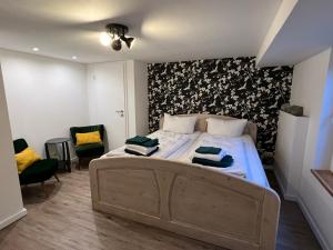 a bedroom with a bed with two towels on it at Platell Ferienhäuser Harz Lonau in Herzberg am Harz