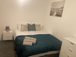 a bedroom with a bed with two towels on it at Riverside by Teil Luxurious one bed Apartment in Preston