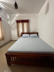 a bedroom with a large bed in a room at Takashi Homestay North Paravur Near Muziris in North Paravur