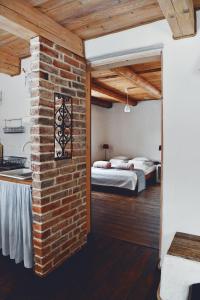 a room with two beds and a brick wall at Lavendowo in Piechowice