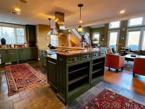 a kitchen with an island in the middle of a room at Presidential View Ski-in Ski-out Townhome with Amazing Views in Bretton Woods
