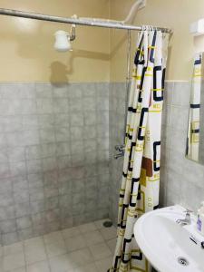 a bathroom with a shower and a sink at Pristine Luxury 2 bedroom Apartment-South C in Nairobi
