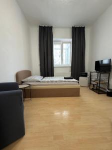 a bedroom with a bed and a television in it at Pension Moravia in Olomouc