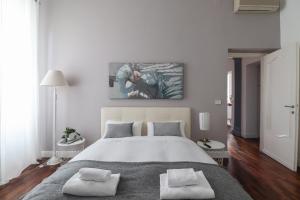 a bedroom with a large bed with two pillows at Luxury and elegant apartment Rome Vatican in Rome