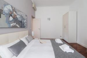 a bedroom with a large white bed in a room at Luxury and elegant apartment Rome Vatican in Rome