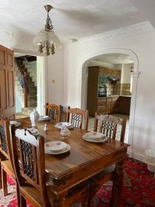 a dining room with a wooden table and chairs at Lovely 10-Bed House in Birmingham with a big drive in Birmingham