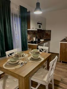 a kitchen with a wooden table with plates on it at Vila Bosa - Stara planina in Crni Vrh