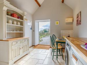a kitchen with a counter and a table with chairs at 1 Bed in Wootton Under Edge EARBA in Charfield