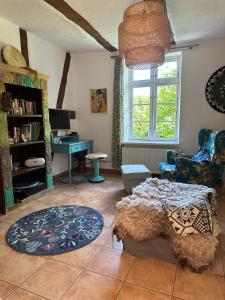 a living room with a bed and a desk at Mecklenbü mit Teich, Kamin, Sauna und Hotpott in Dargun