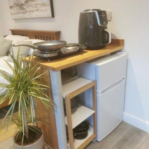a table with a coffee maker on top of it at Luxury cabin with hot-tub in Cheltenham