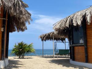Marinus Eco Lodge في Canoas: كوخ على الشاطئ مع المحيط في الخلفية