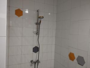 a bathroom with a shower with orange squares on the wall at Jad tunis in Tunis