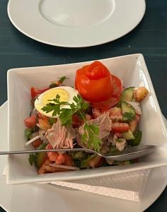 a bowl of food with a egg and vegetables at L'artisan in Hergla