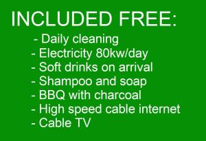 a green sign that reads induced free daily cleaning electricity soft drinks on at Baan Leelawadee - 4 Bed Villa near Beach Pattaya in Nong Prue