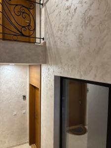 a hallway with a door and a balcony in a building at Tenea Apartment & SPA in Zlatibor +34 photos