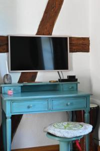 a blue dresser with a tv on top of it at Mecklenbü mit Teich, Kamin, Sauna und Hotpott in Dargun